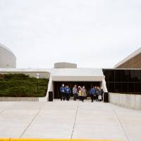 tour group stands in front of the fieldhouse